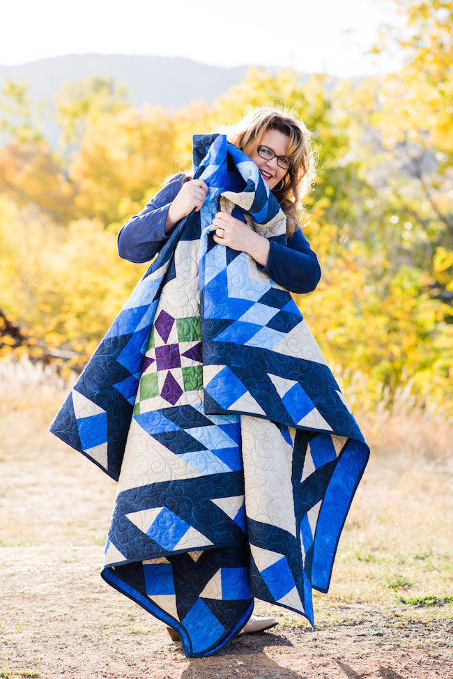 Nancy McNally Holding her Blazing Star Quilt