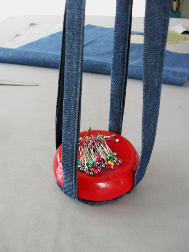 red pincushion showing plant hanger straps