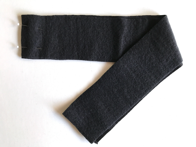 Strip of black fabric with pins