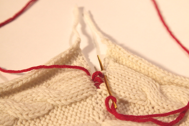 Seaming knits with red yarn