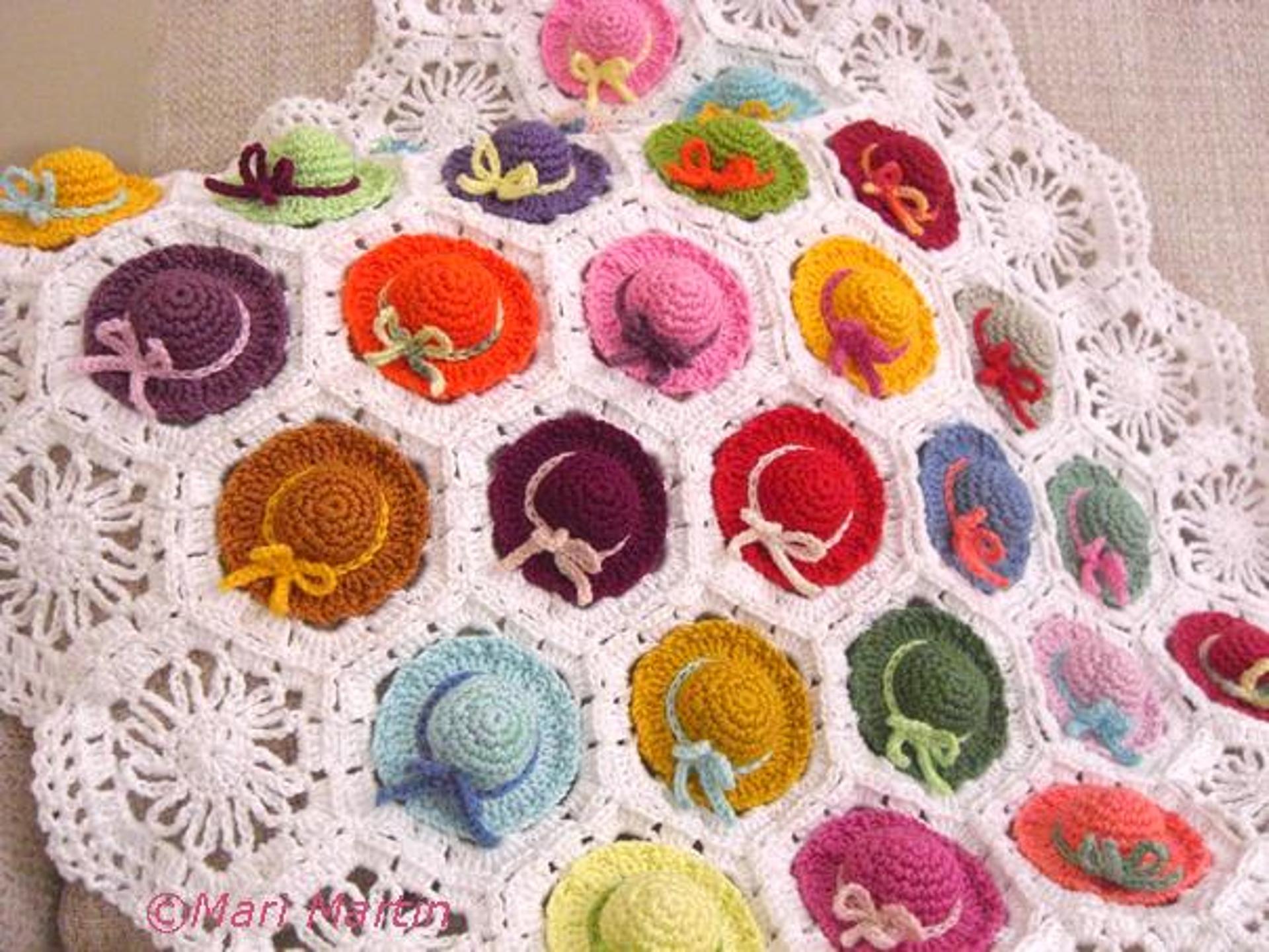 colorful crochet baby blanket with mini hats