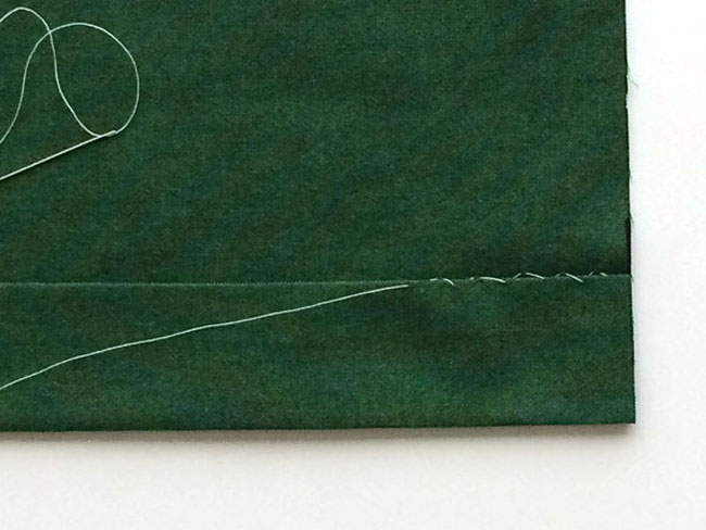 hemming-stitch on green wool