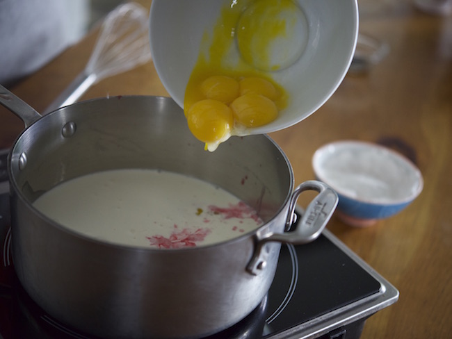 egg yolks pouring in pot