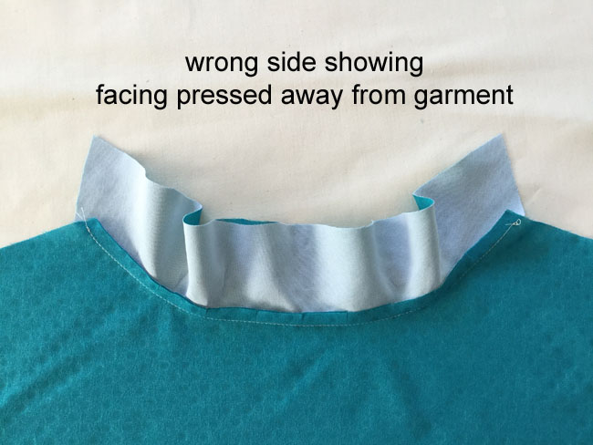 facing pressed away inside the garment