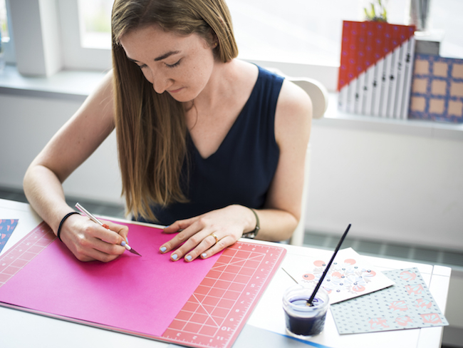 Tracy cutting pink paper