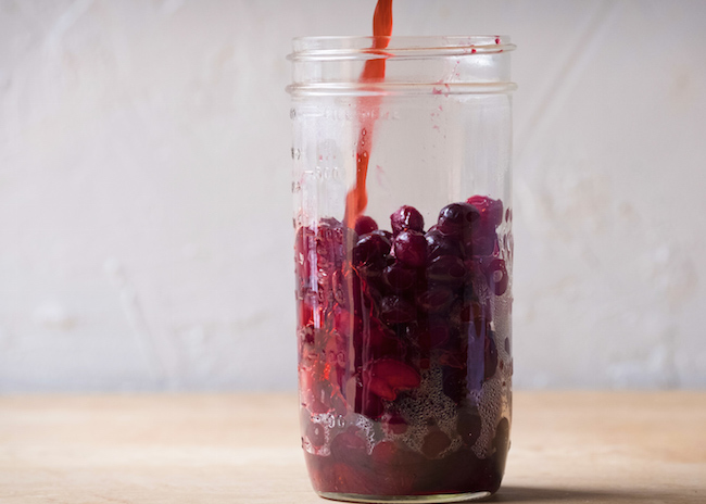 Pouring Brine into Jar with Cranberries