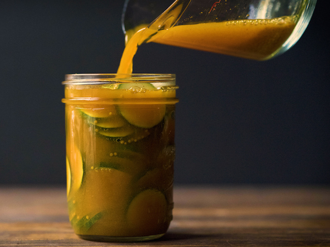 Pouring Brine into Jar with Zucchini Slices