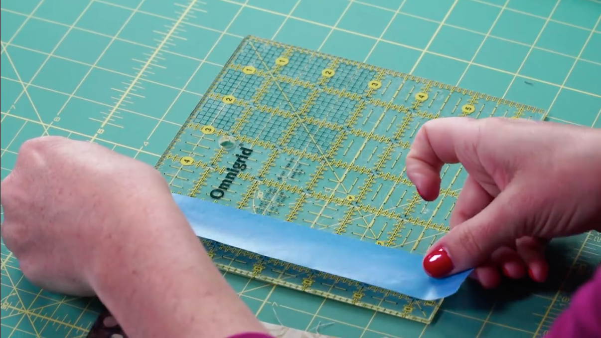 Placing Painters Tape on Quilting Ruler