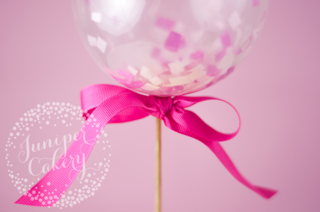 DIY mini balloon cake topper and pink ribbon