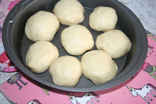 Rolls divided into portions in cake pan