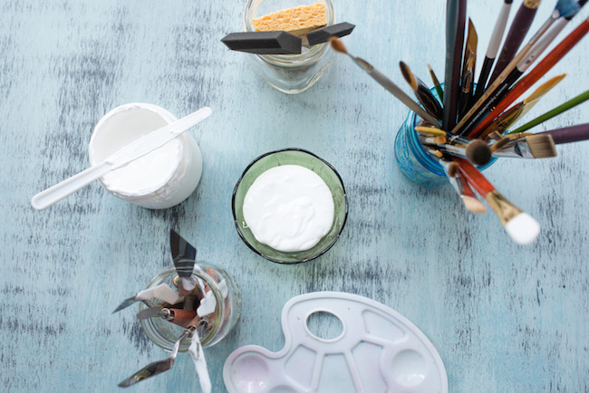 Painting Supplies arranged around bowl of white gesso