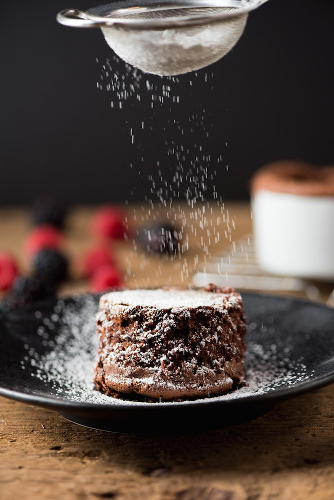 Dusting Powdered Sugar on Small Chocolate Cake