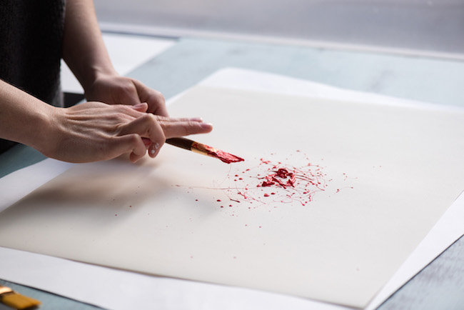 Splattering Red Acrylic Paint on Paper