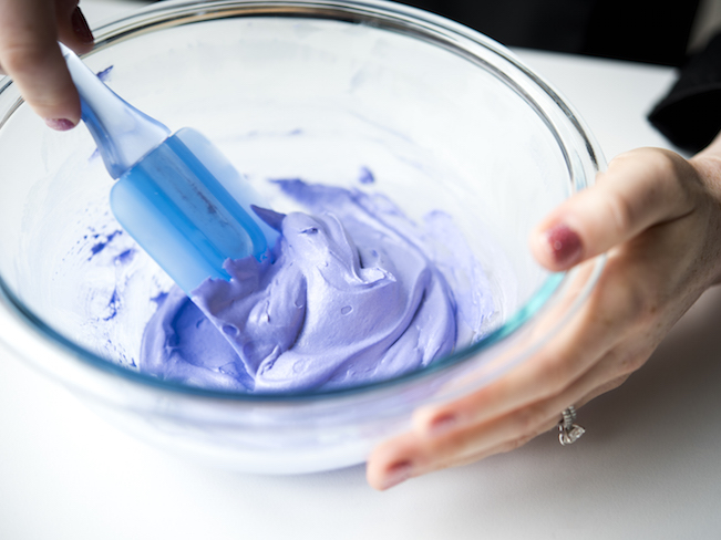 Stirring Purple Royal Icing in Mixing Bowl