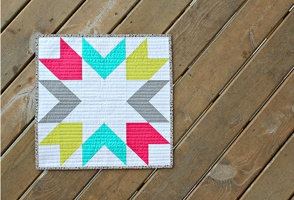 starburst mini quilt on wood background