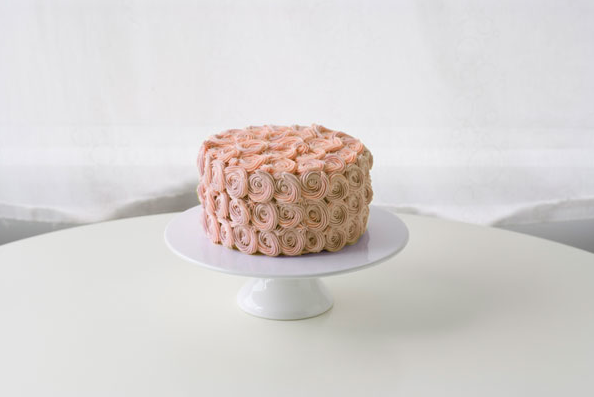 Pink Rosette-Covered Cake on White Stand