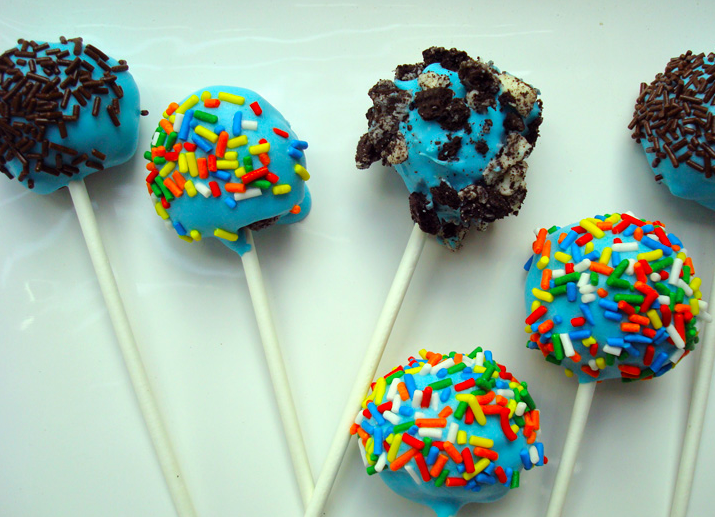 Cake Pops Covered with Sprinkles and Oreo Crumbles All in Row