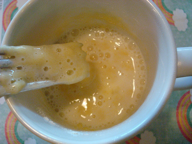Fork Mixing Egg into Cake Mixture in Mug