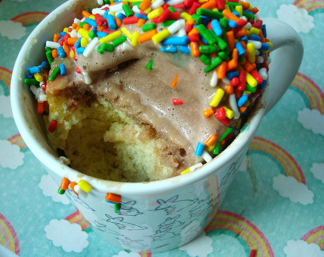 Cake in a Mug with Sprinkles and Bite Missing