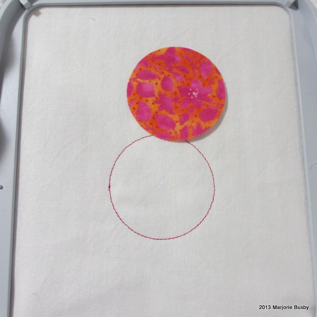 Fabric with Appliqué atop Embroidered Circle