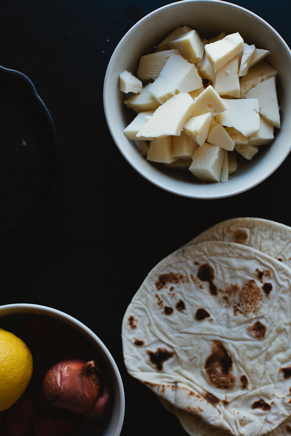 Bowl of Sliced Cheese, Tortillas, Onion and Lemon