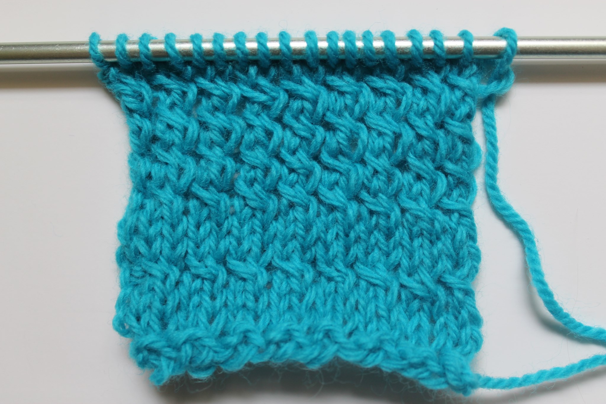 Close Up of Left Twist Stitch on Needle