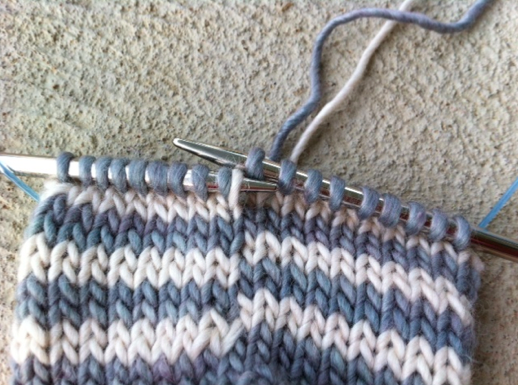 Closeup of Knitting Needle Grabbling Yarn Loop