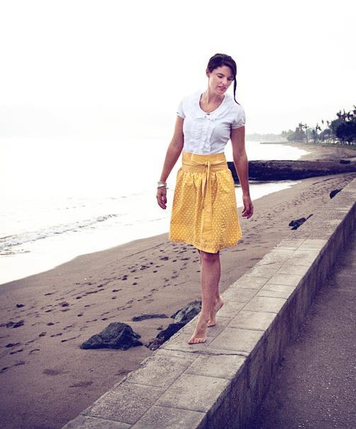 Woman in Yellow Skirt Walking on Beach