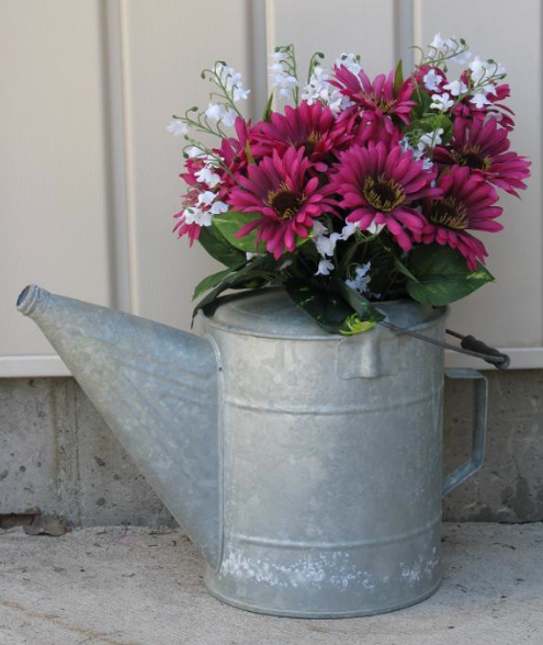 Metal Watering Can wiht Pink and White Flowers Inside