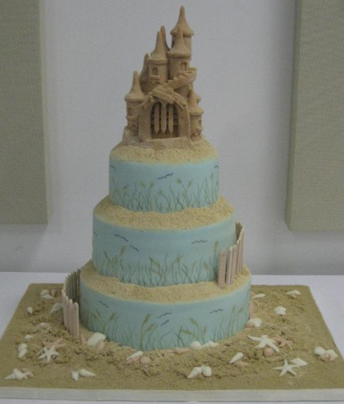 Beach-Themed Tiered Cake Topped with Sand Castle 