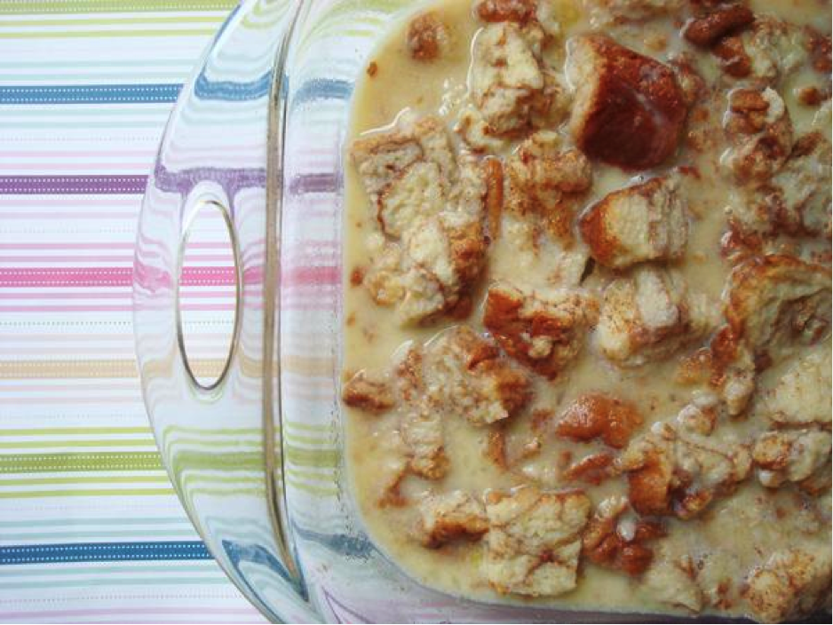 Pyrex Pan Containing Bread Pudding Mixture Atop Striped Table