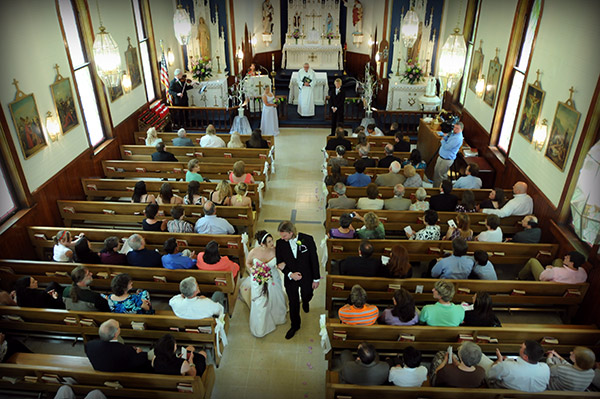 Photo of Bride and Groom Walking Down Aisle at Church