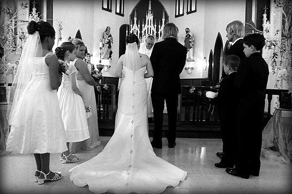 Black and White Photo of Couple Standing at the Alter