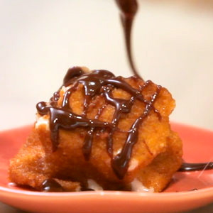 Chocolate Syrup Drizzling Over Marshmallows on Plate