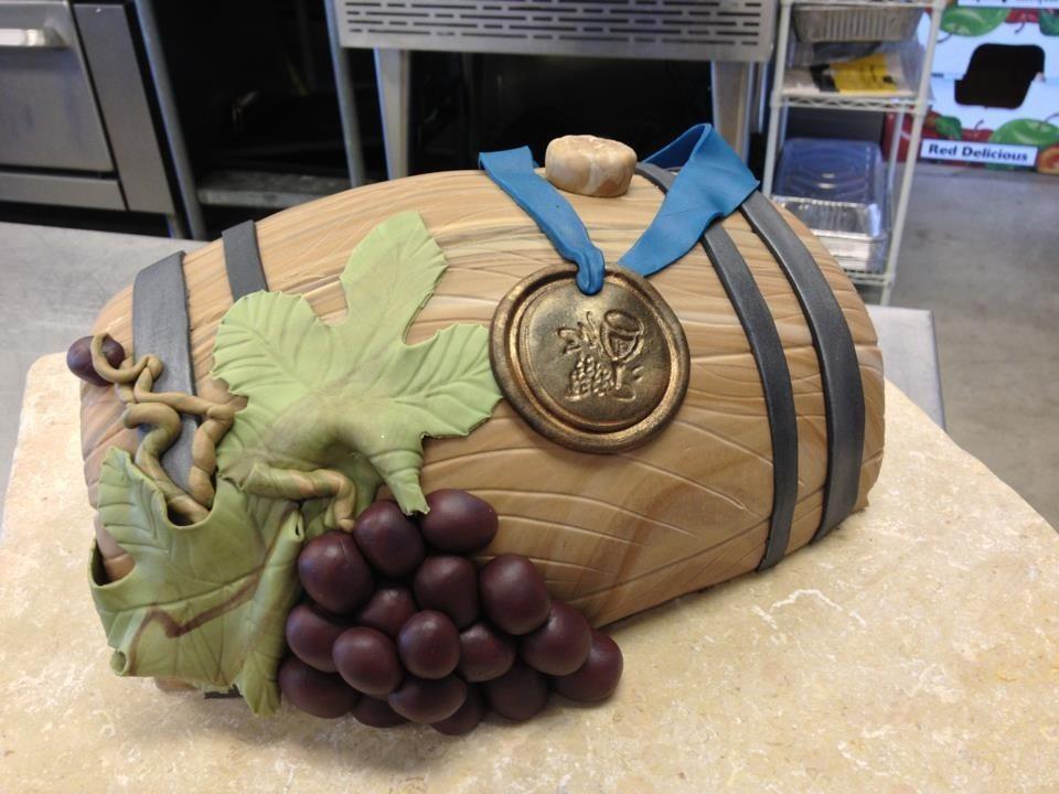 Cake in Shape of Half of Wine Barrel Topped with Blue Ribbon and Grapes