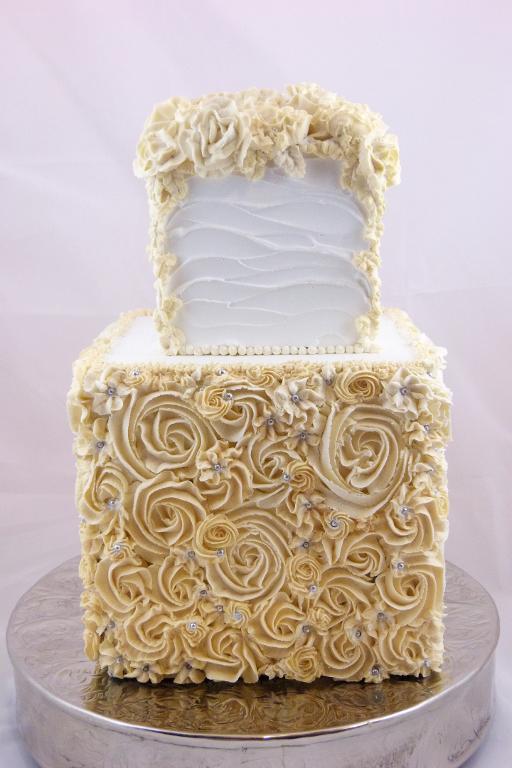 White and Cream Wedding Cake with Ruffles and Floral Pattern