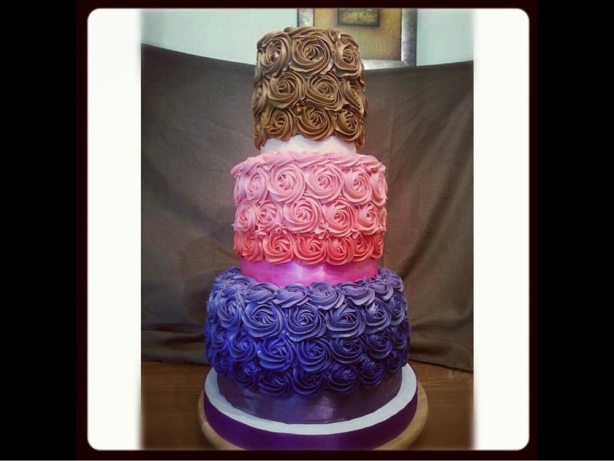 Tiered Cake Covered in Multicolor Icing Roses