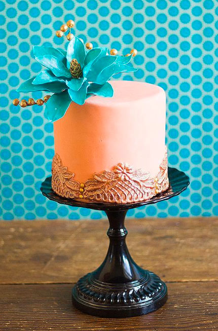 Peach-Colored Cake with Sparkling Flower Topper Against Polka Dot Background