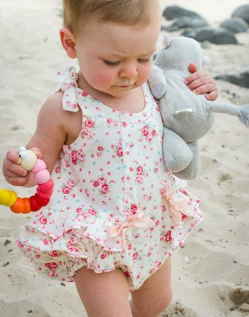 Baby Wearing Romper and Carrying Stuffed Animal