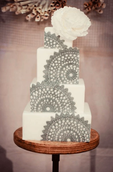 White Cake with Green Doilies Topped with White Rose