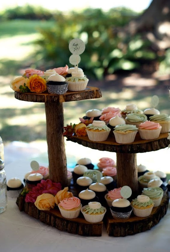 Rustic Wooden Stand Featuring Array of Colorful Cupcakes