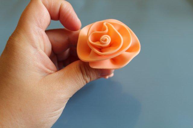 Hand Displaying First Layer of Fondant Rose