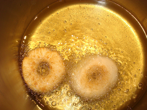 Two Donuts Frying in Pan with Oil