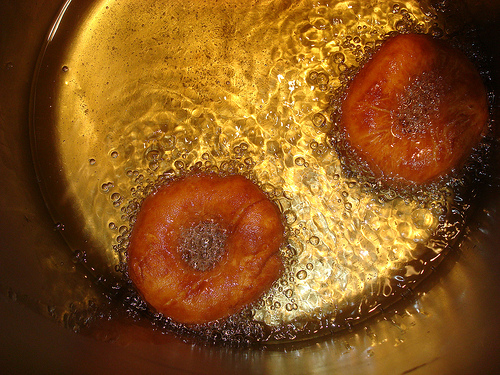 Two Donuts, Now Golden, Frying in Pan with Oil