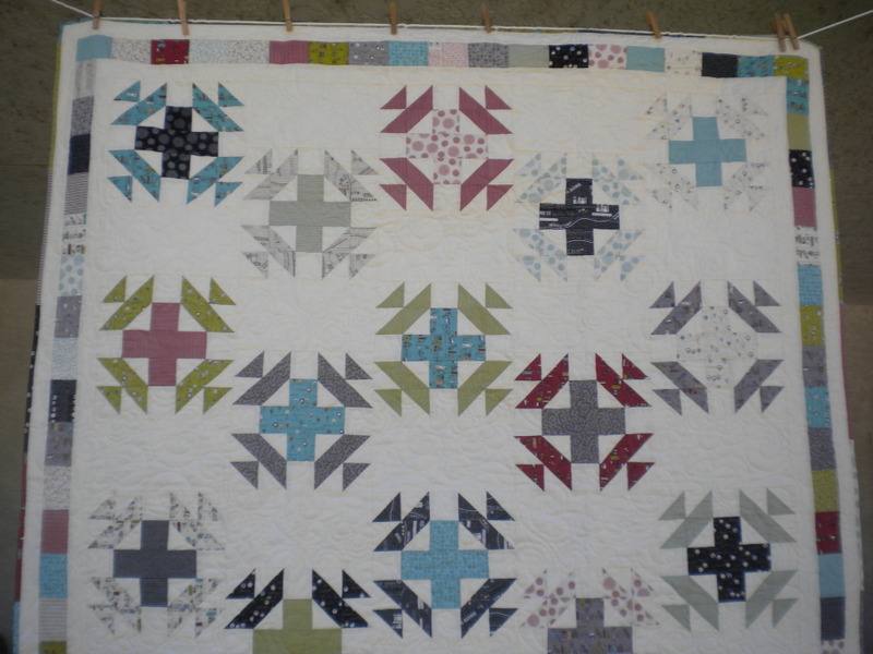 White Quilt with Accented Cross Patterns