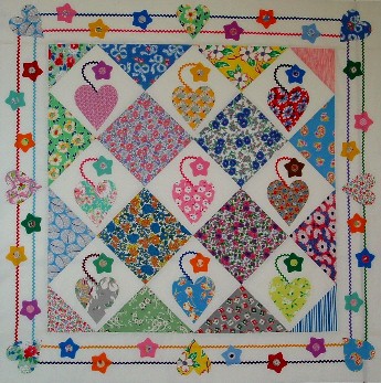 Colorful Diamond Patterned Quilt Hanging on Wall