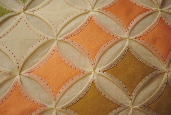 White and Orange Quilt with Raised Diamond-in-Circle Pattern