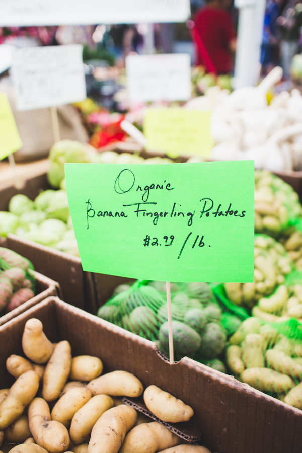 Sign for Organic Produce Amidst Boxes of Vegetables