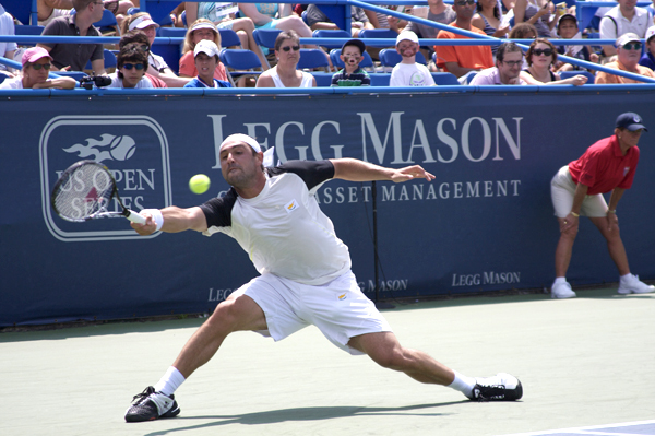 Shot of Tennis Player Lunging for Ball