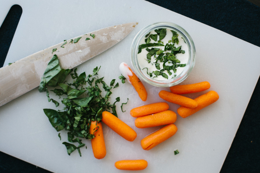 Carrots with Lettuce and Sauce on Cutting Board